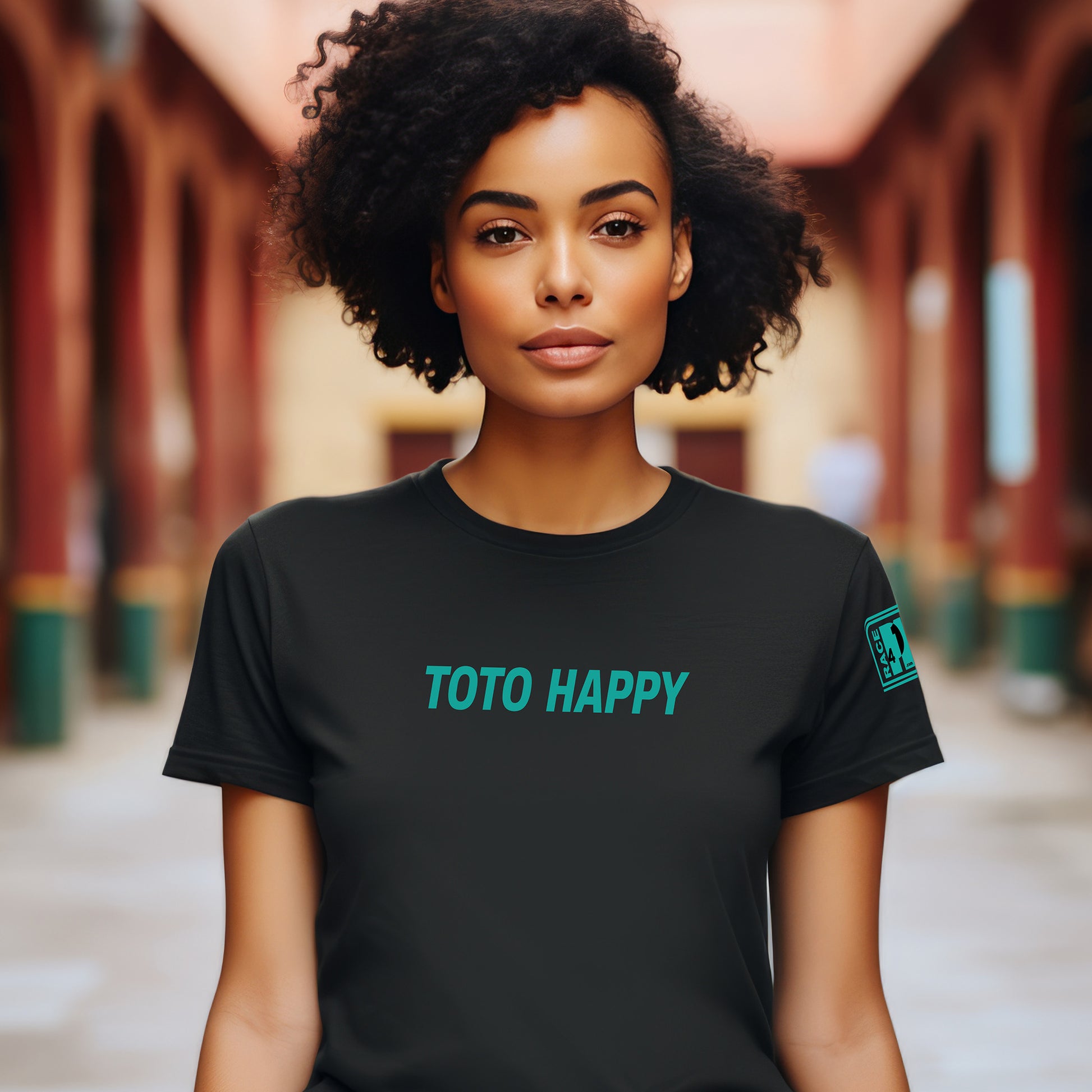 Woman wearing TOTO HAPPY full chest black tee – Race4P1 Originals motorsport lifestyle tee with teal print