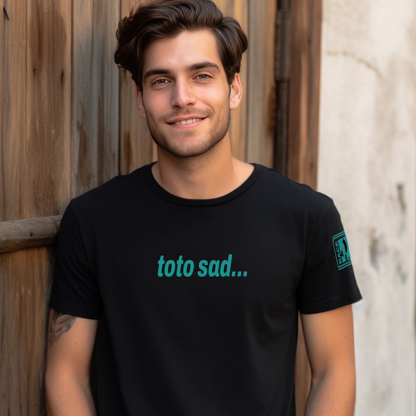 Man wearing TOTO SAD full chest black tee – Race4P1 Originals motorsport lifestyle tee with teal print