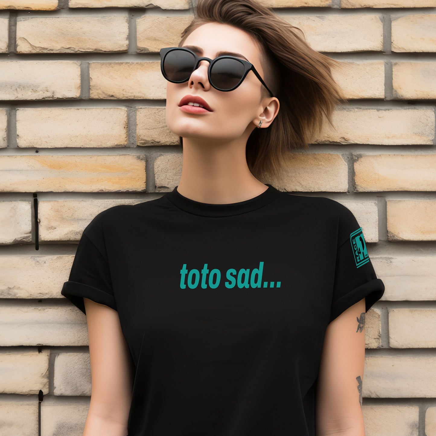 Woman wearing TOTO SAD full chest black tee – Race4P1 Originals motorsport lifestyle tee with teal print
